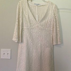 White dress with cutout overlay, and beading along neckline.